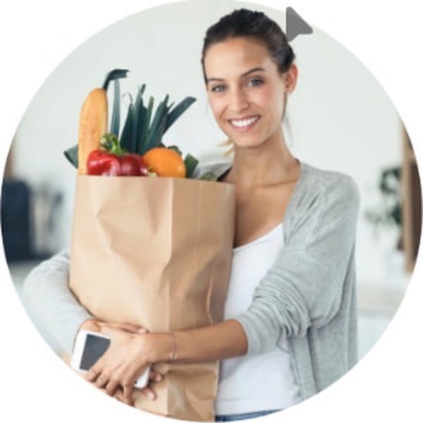 A woman carrying a bag of groceries